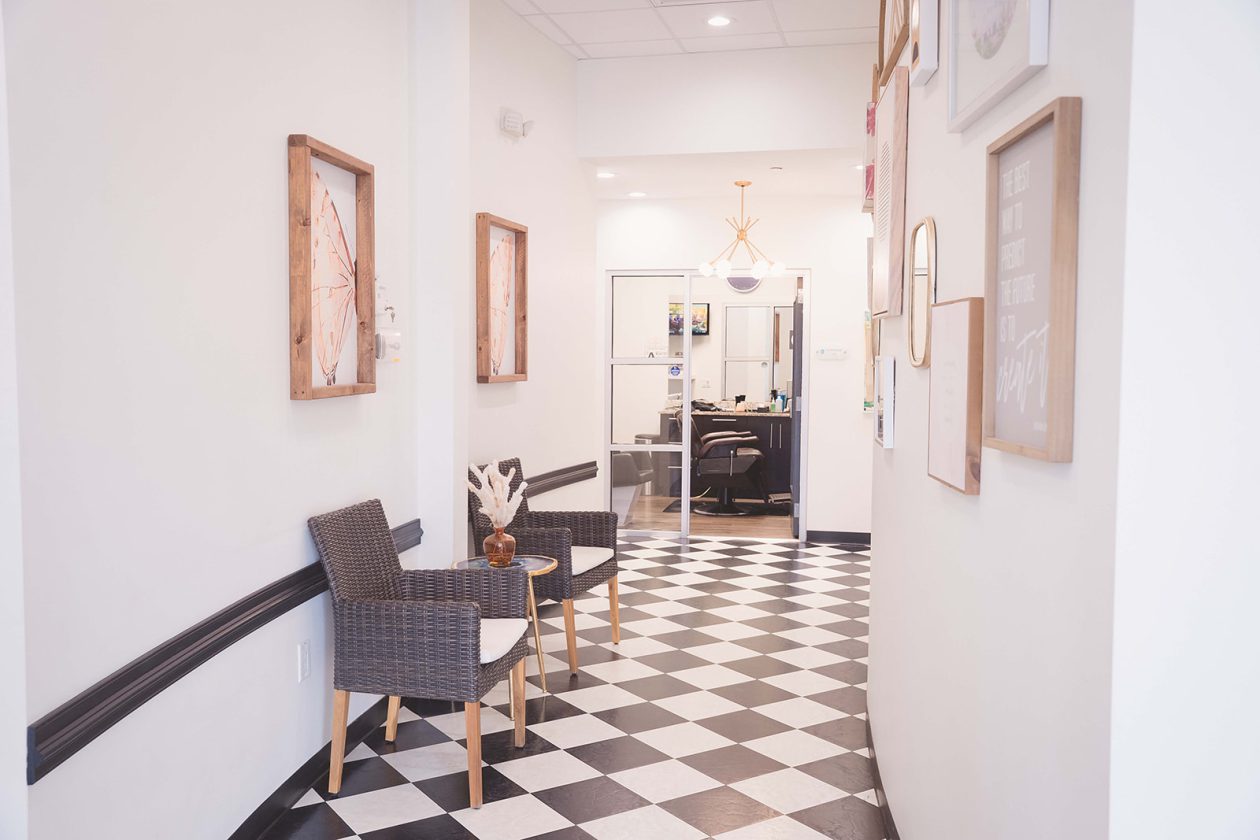 Entrance and lounge at WanderLux Southpoint with checkered floor and framed art
