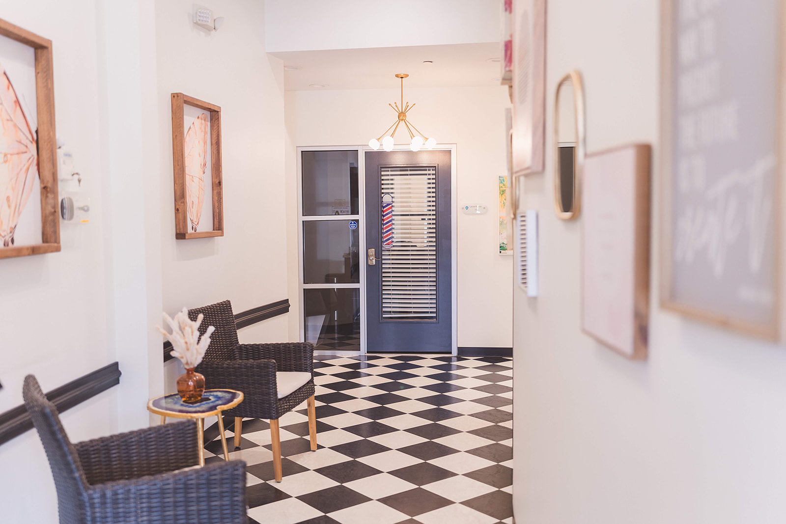 Lobby and waiting area at WanderLux Southpoint with checkerboard floor and a chandelier