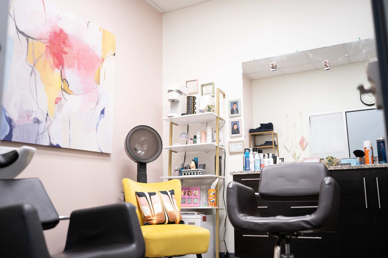 WanderLux salon suite with a shampoo bowl, hooded dryer and colourful abstract art