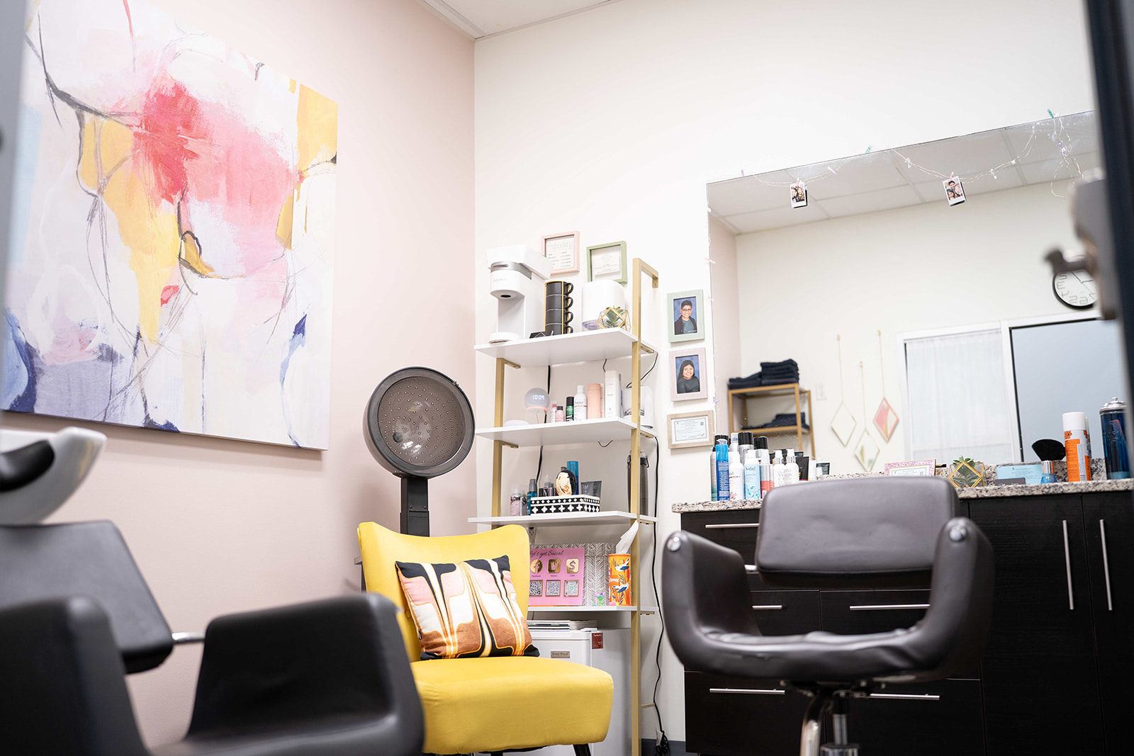 WanderLux salon suite with a shampoo bowl, hooded dryer and colourful abstract art