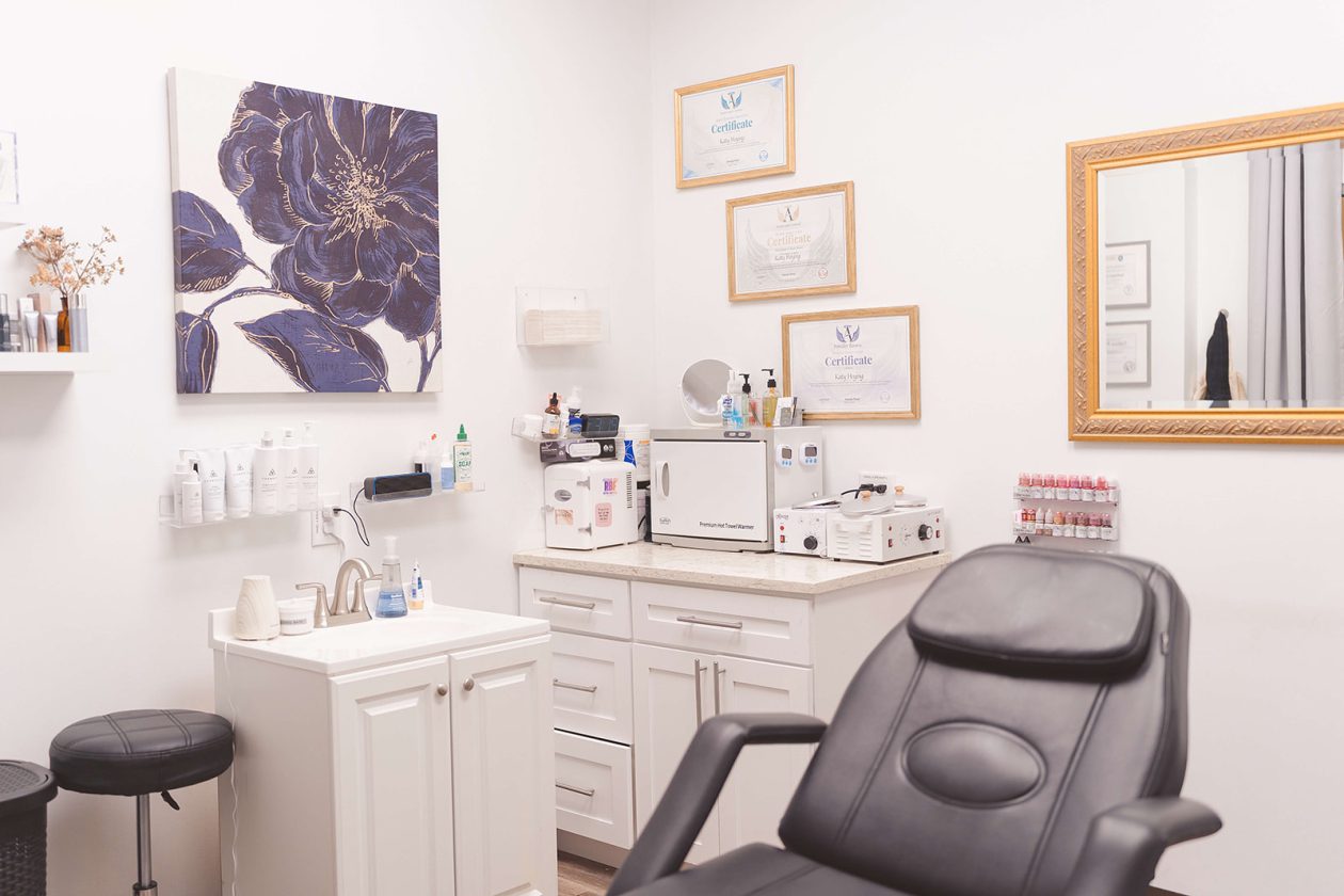Esthetician treatment room at WanderLux University Hill with a facial bed and white cabinetry