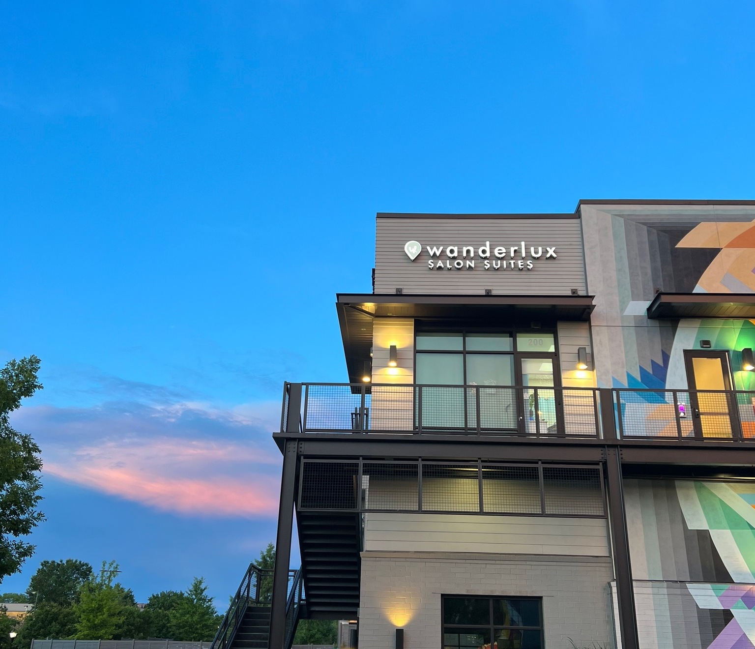 WanderLux Salon Suites University Hill exterior at dusk