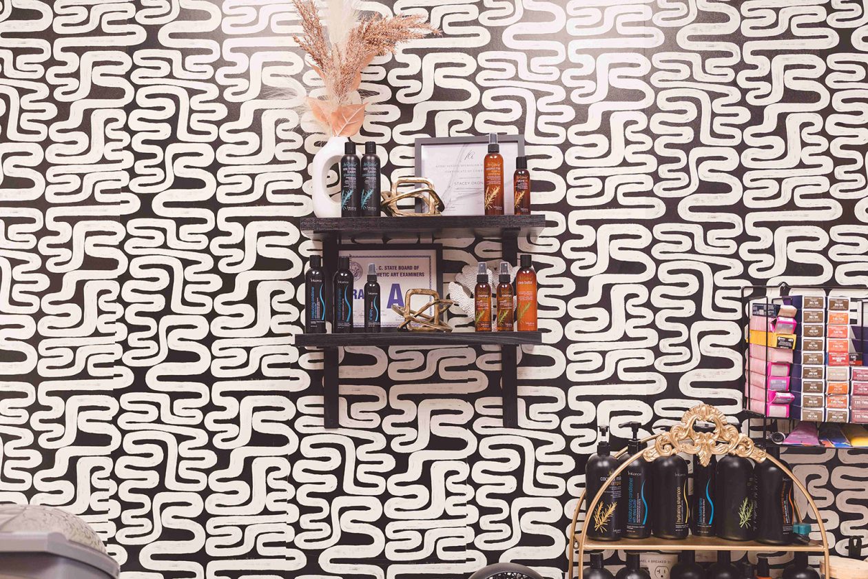 WanderLux suite at University Hill with graphic black and white wallpaper and retail shelving
